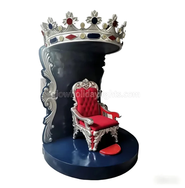This grand, themed decoration features an ornate red-and-silver throne beneath a giant, gem-adorned crown. Crafted with intricate scrollwork and a regal color scheme, it serves as a stunning photo booth or centerpiece for holiday events, royal-themed parties, or festive displays.