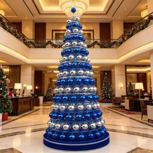 Luxury hotel lobby featuring a large spherical Christmas tree with festive lights and baubles during holiday season